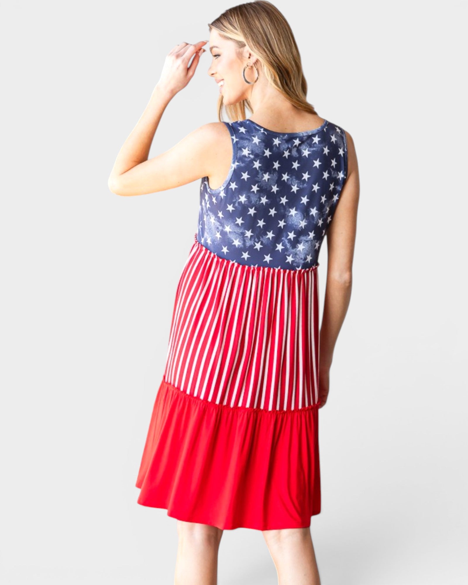 Woman wearing a dress with a red, white, and blue pattern on a white background