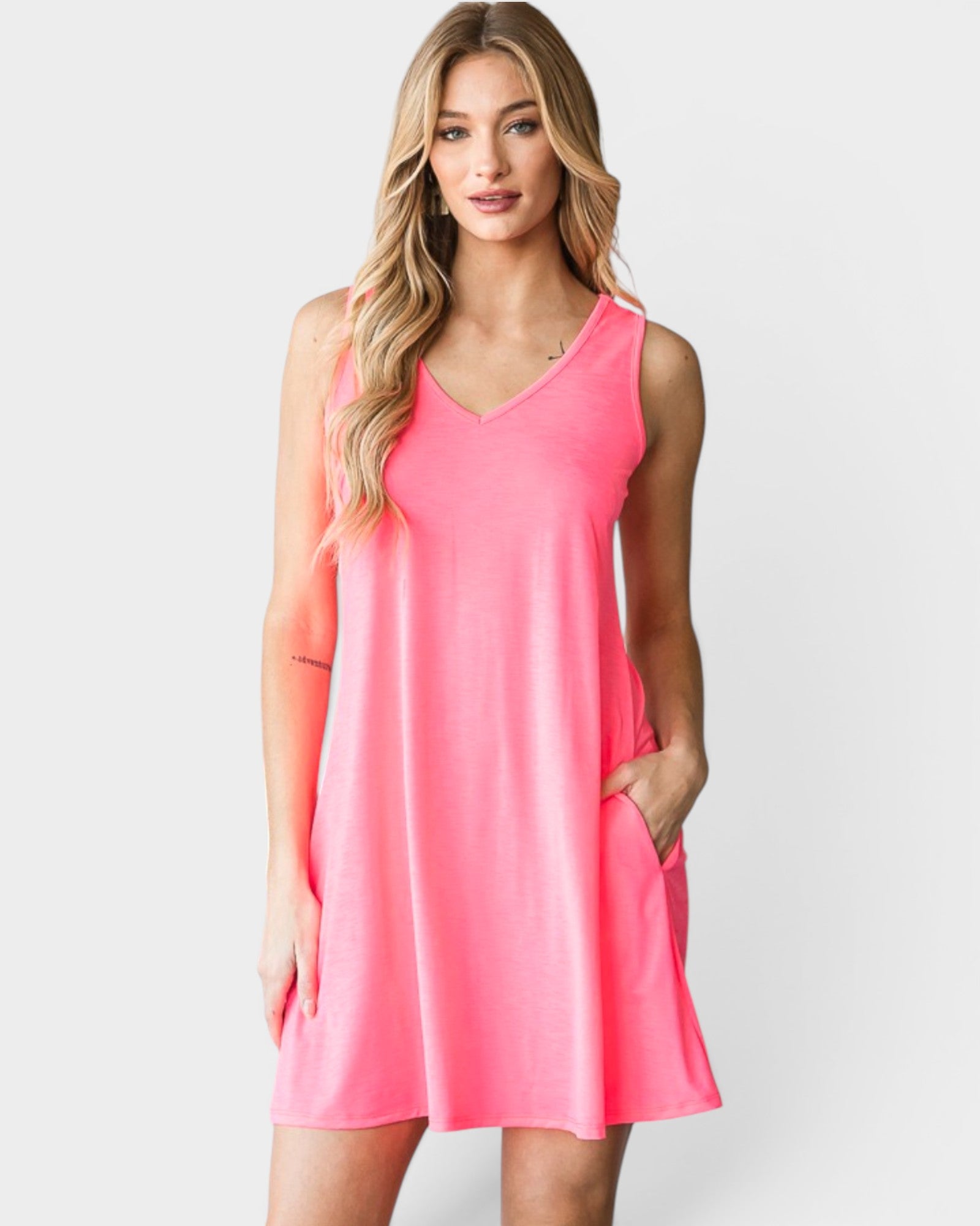Woman wearing a pink sleeveless dress on a white background