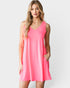 Woman wearing a pink sleeveless dress on a white background