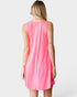 Person wearing a pink sleeveless dress on a white background
