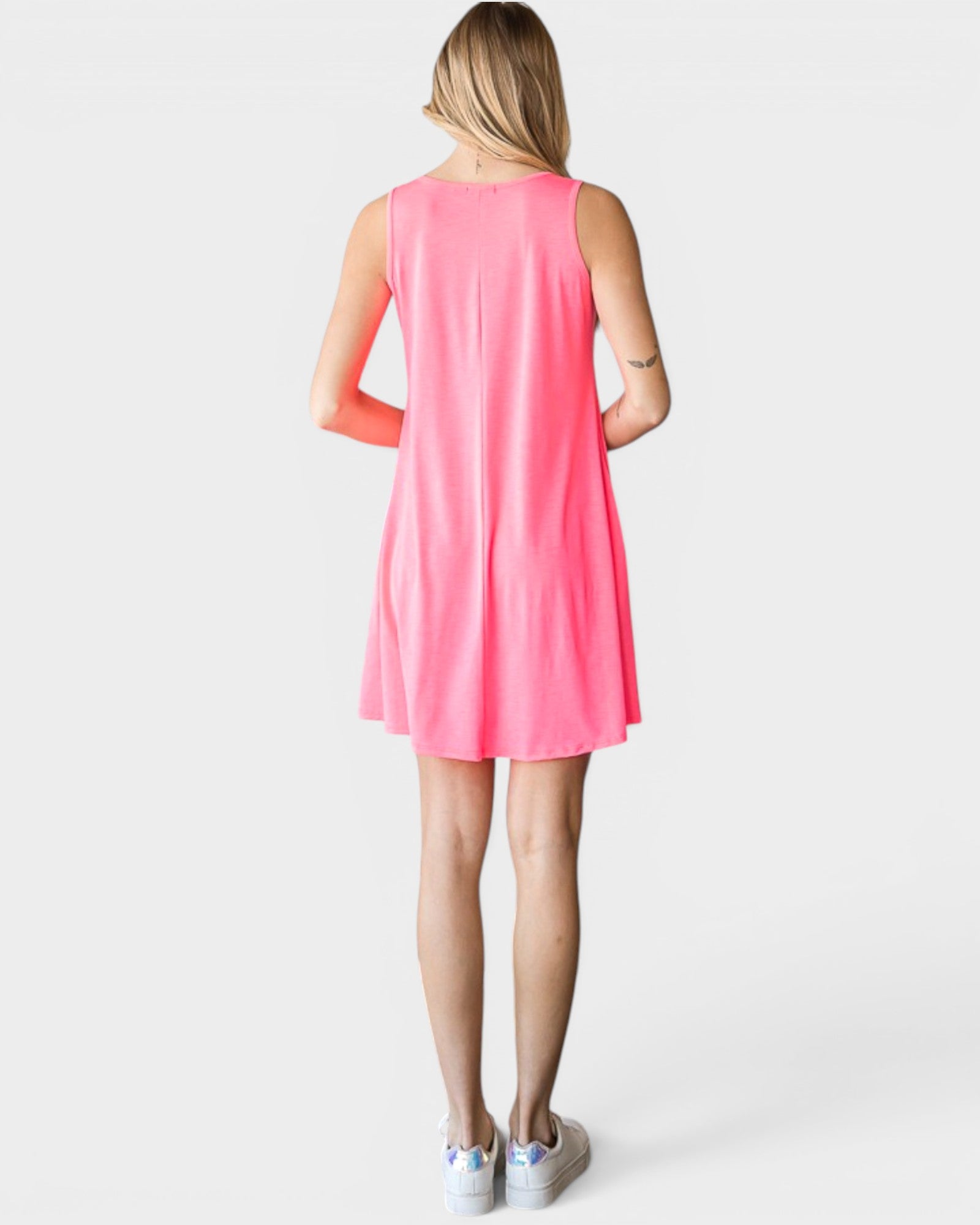 Woman wearing a pink sleeveless dress on a white background