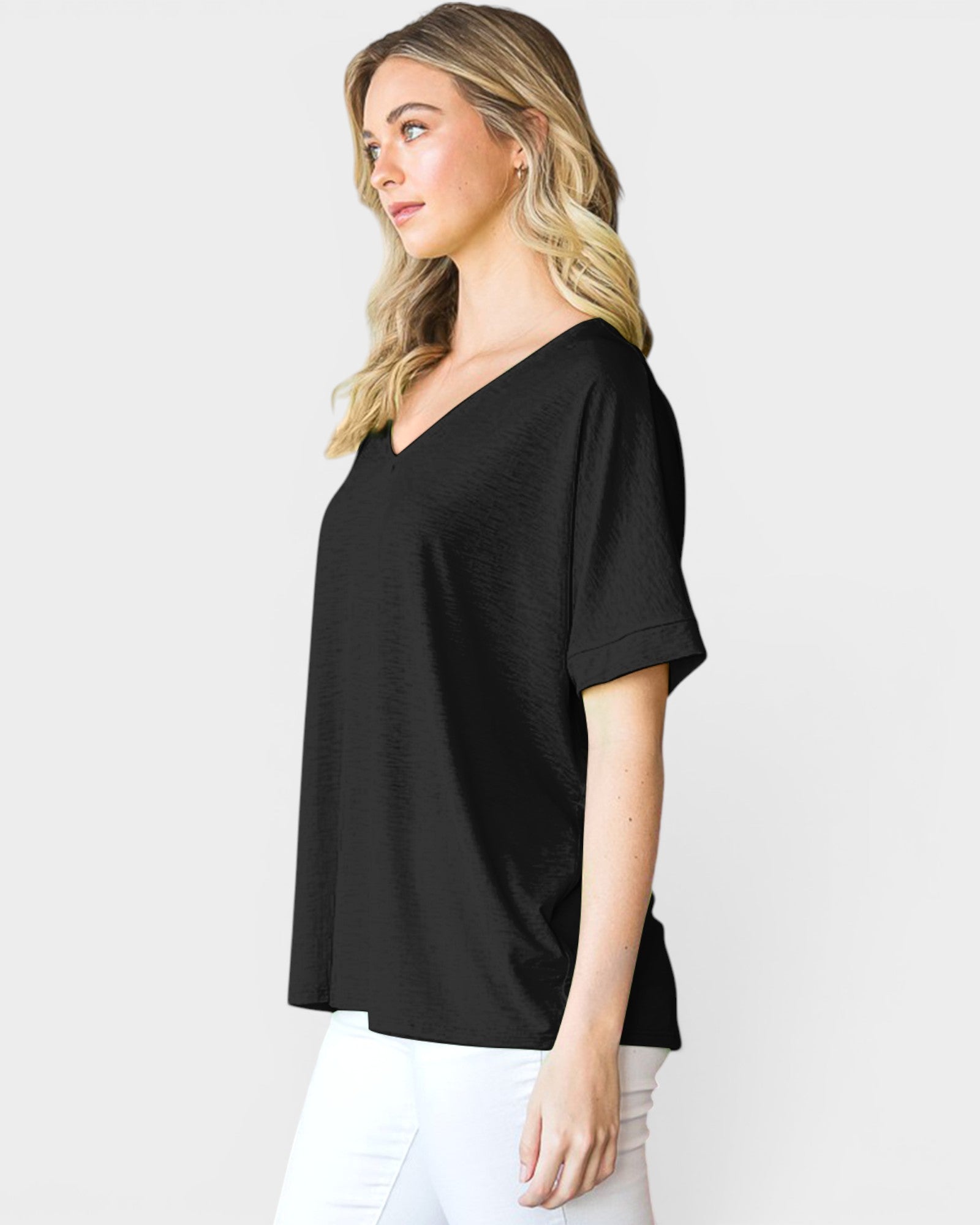 Woman wearing a black V-neck t-shirt against a white background