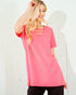Woman wearing a pink t-shirt with cut-out design on a white background
