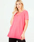Woman wearing a pink top with cut-out details on a white background
