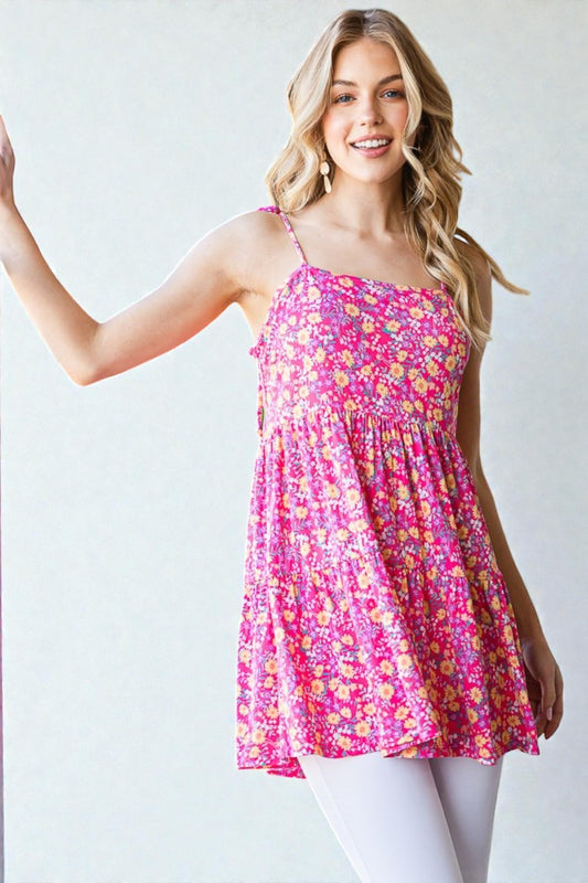 Woman wearing a pink floral dress against a white background