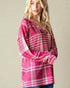 Woman wearing a pink plaid dress against a beige background