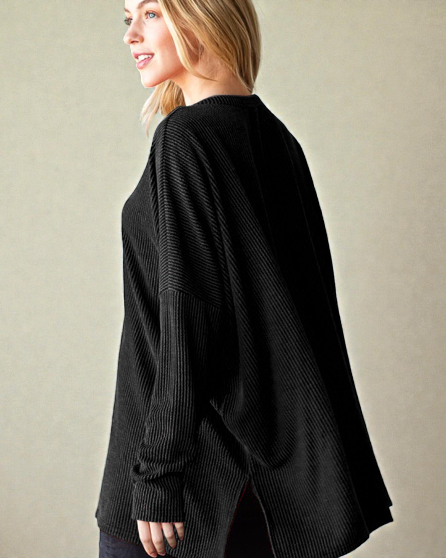 Woman wearing a black sweater against a beige background
