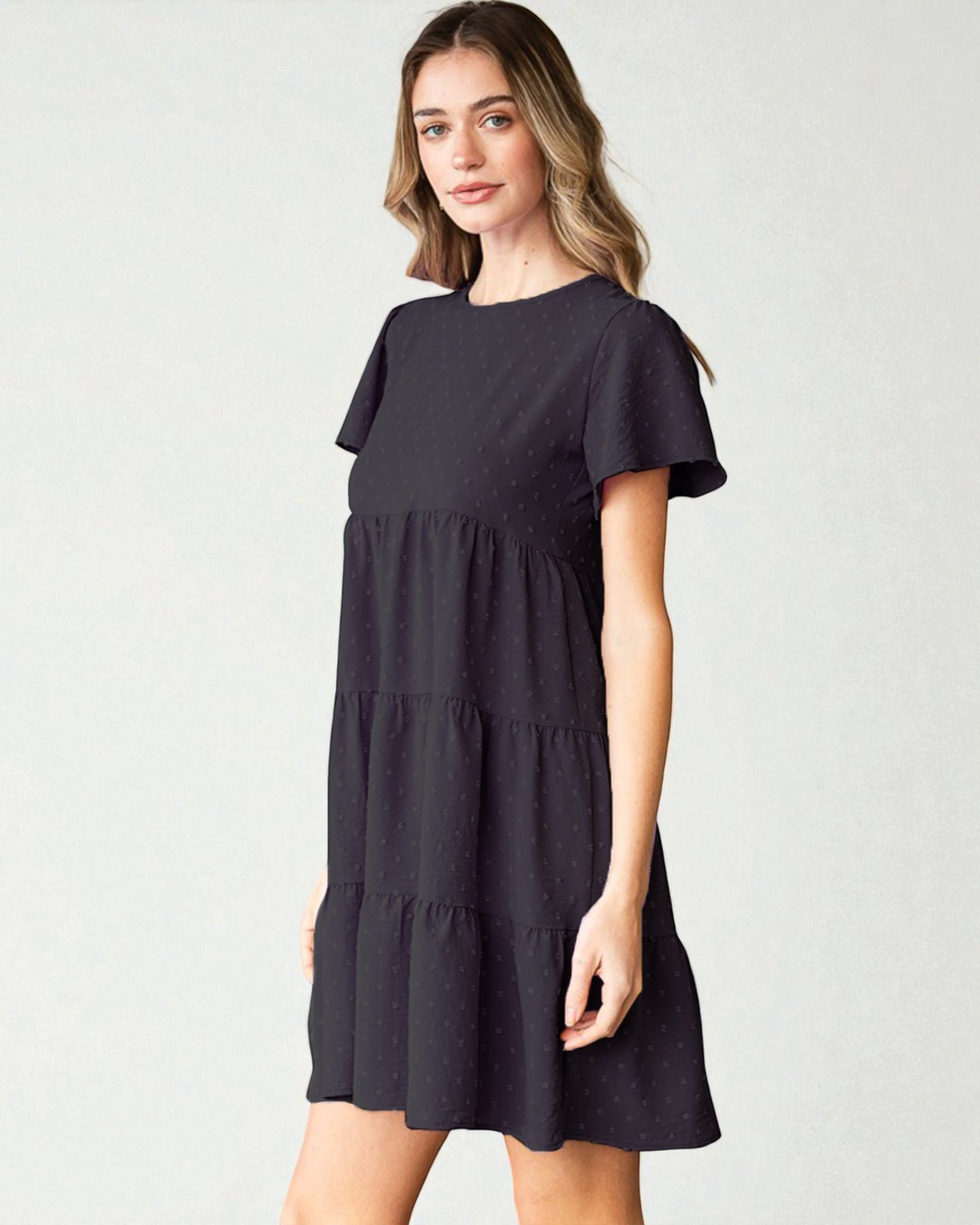 Woman wearing a black dress on a white background