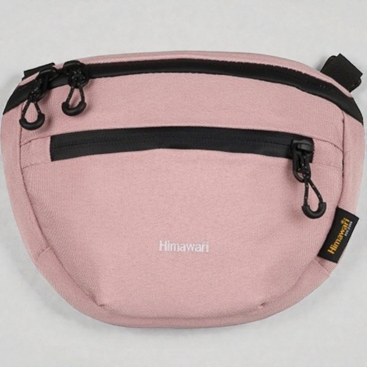Pink waist bag with black zippers and 'Himawari' branding on a light gray background