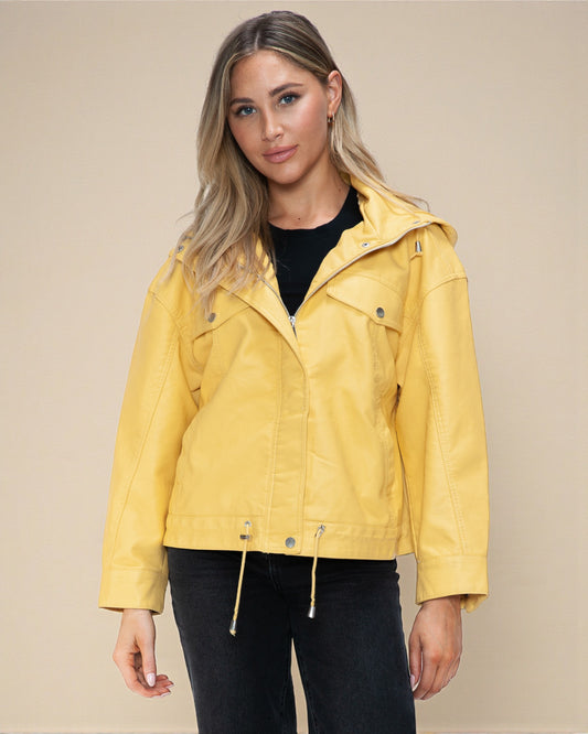 Woman wearing a yellow jacket against a beige background