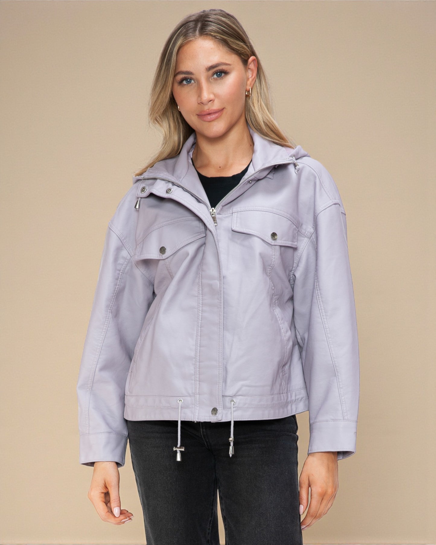 Woman wearing a light gray jacket on a beige background