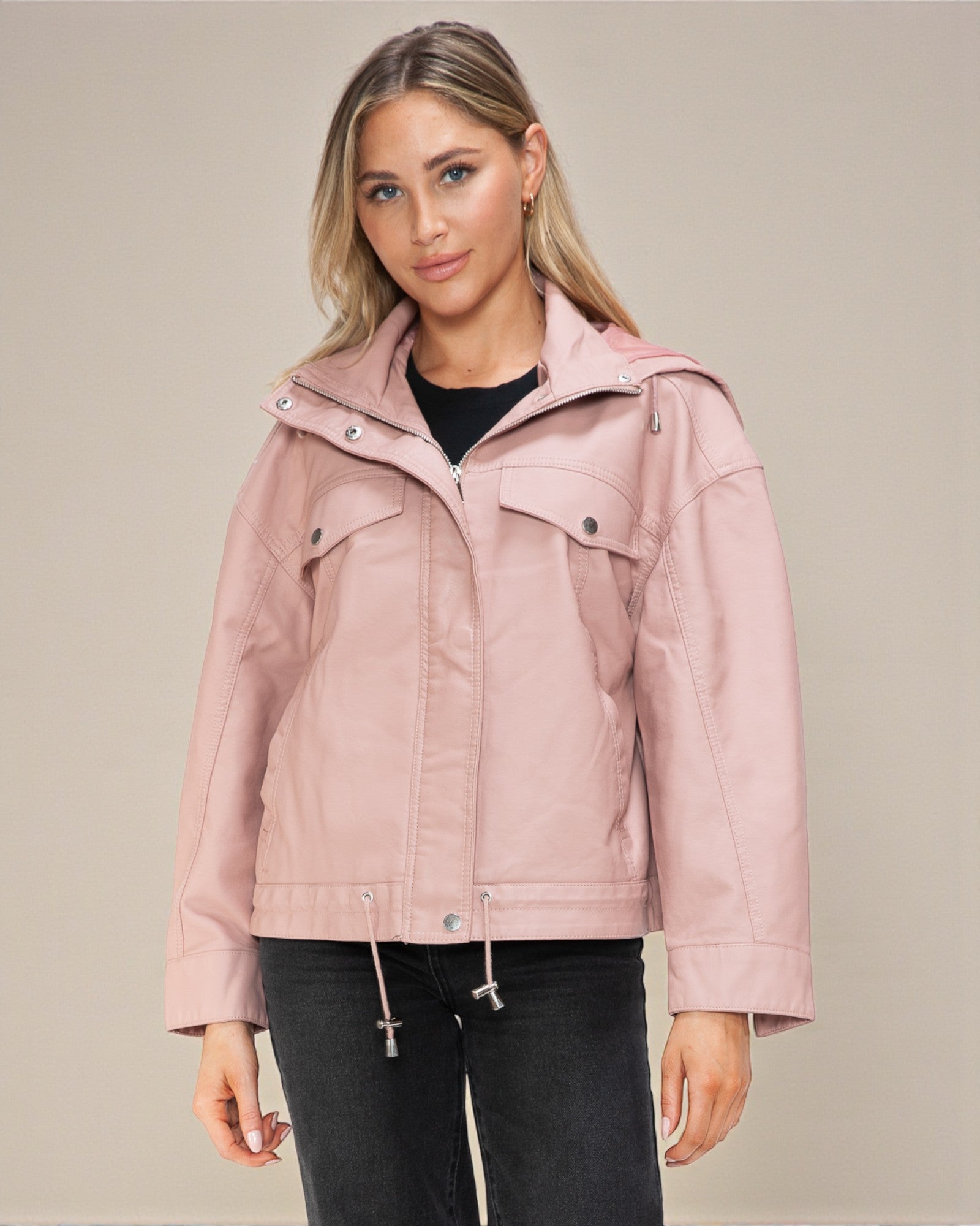 Woman wearing a pink jacket against a beige background