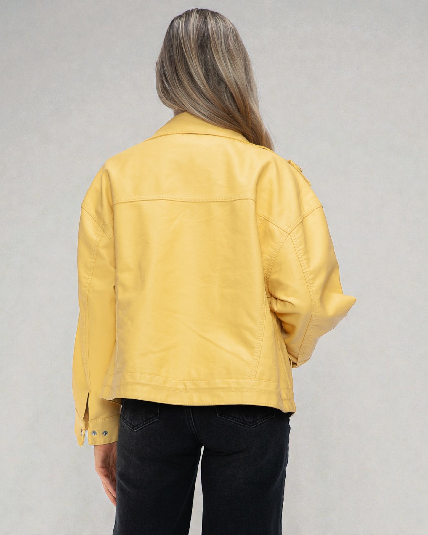Person wearing a yellow jacket on a gray background