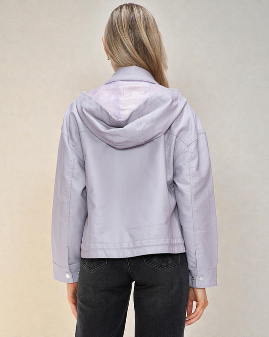 Person wearing a light purple jacket with a hood on a beige background