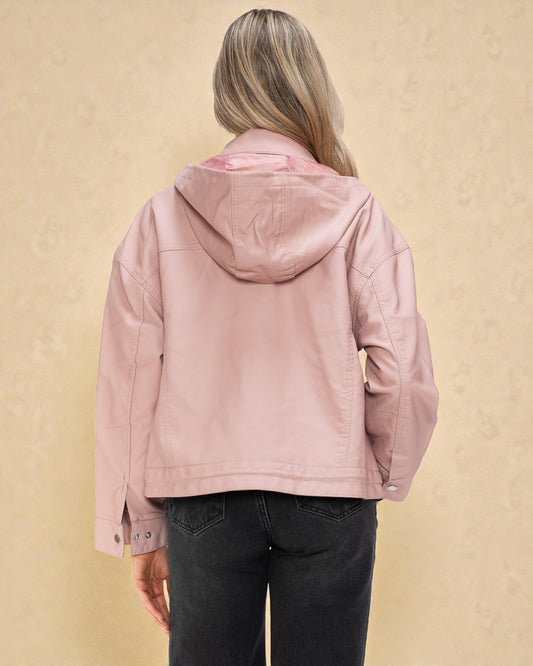 Person wearing a pink hooded jacket on a beige background