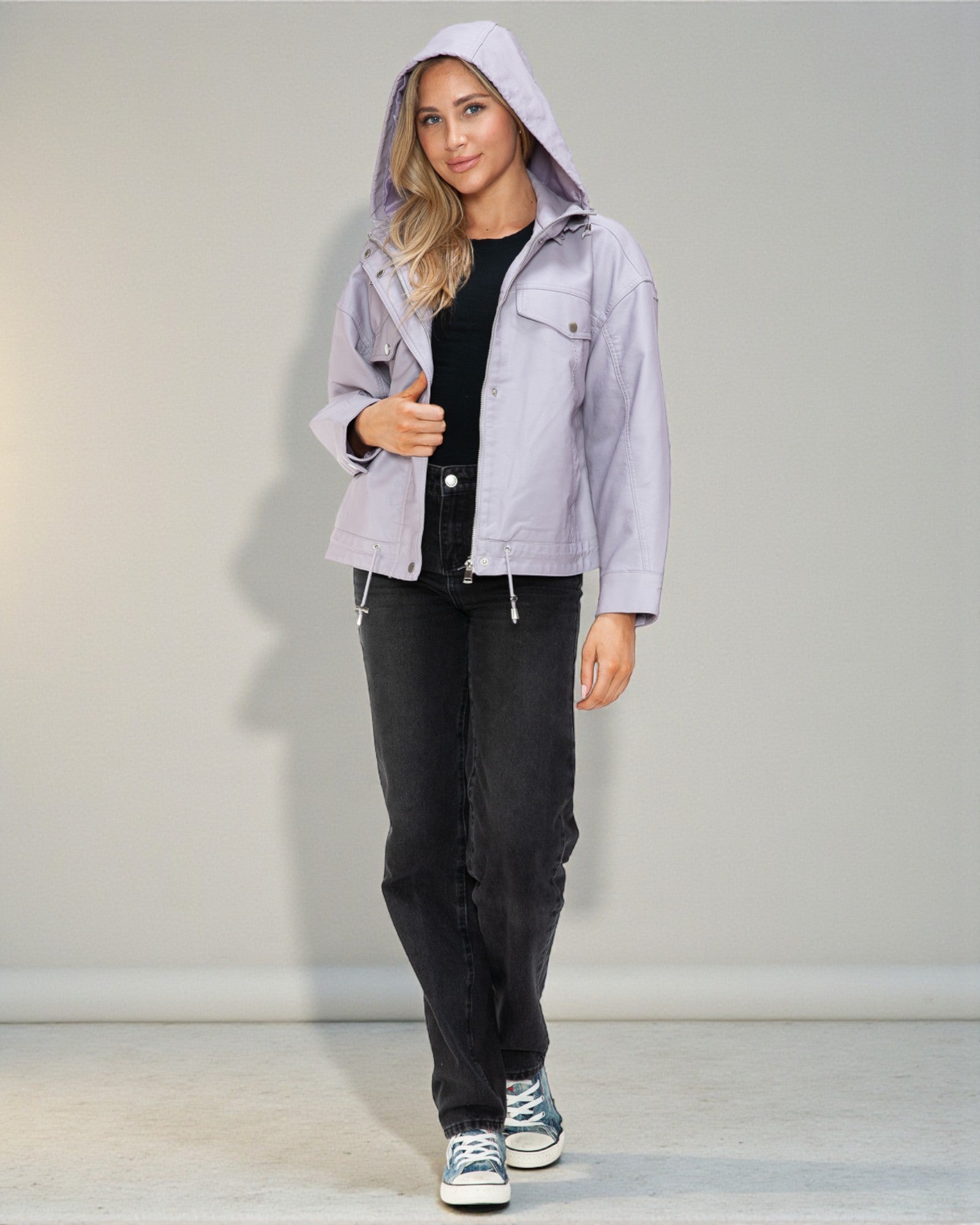 Woman wearing a light gray hooded jacket with a plain background