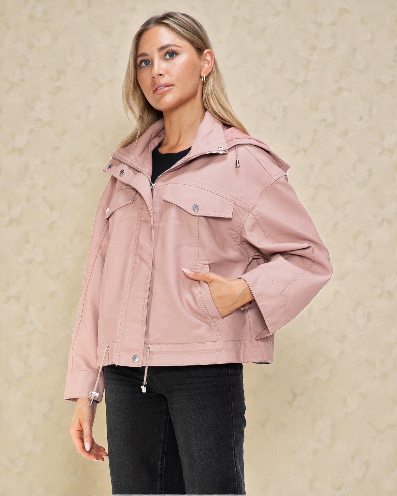 Woman wearing a pink jacket against a beige background