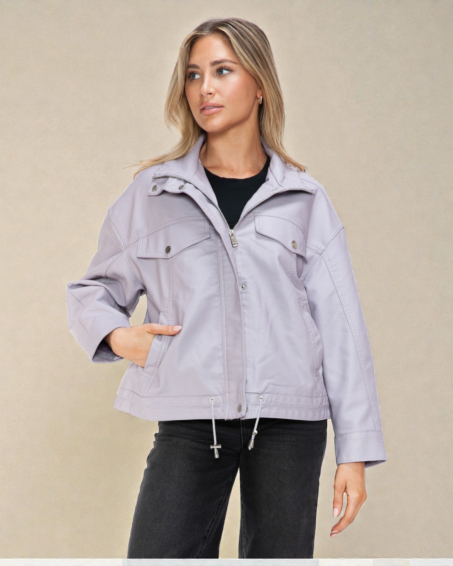 Woman wearing a light purple jacket against a beige background