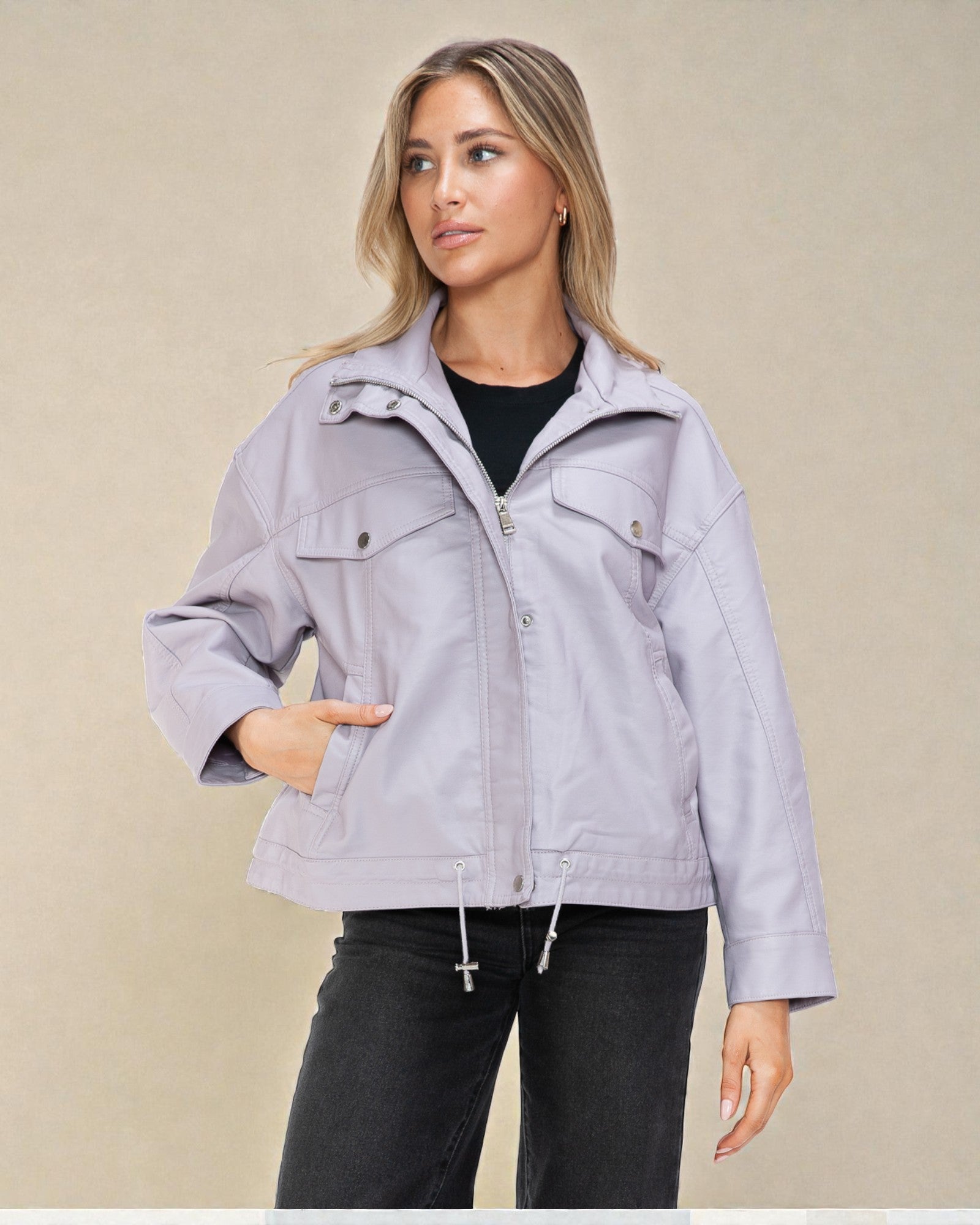 Woman wearing a light purple jacket against a beige background