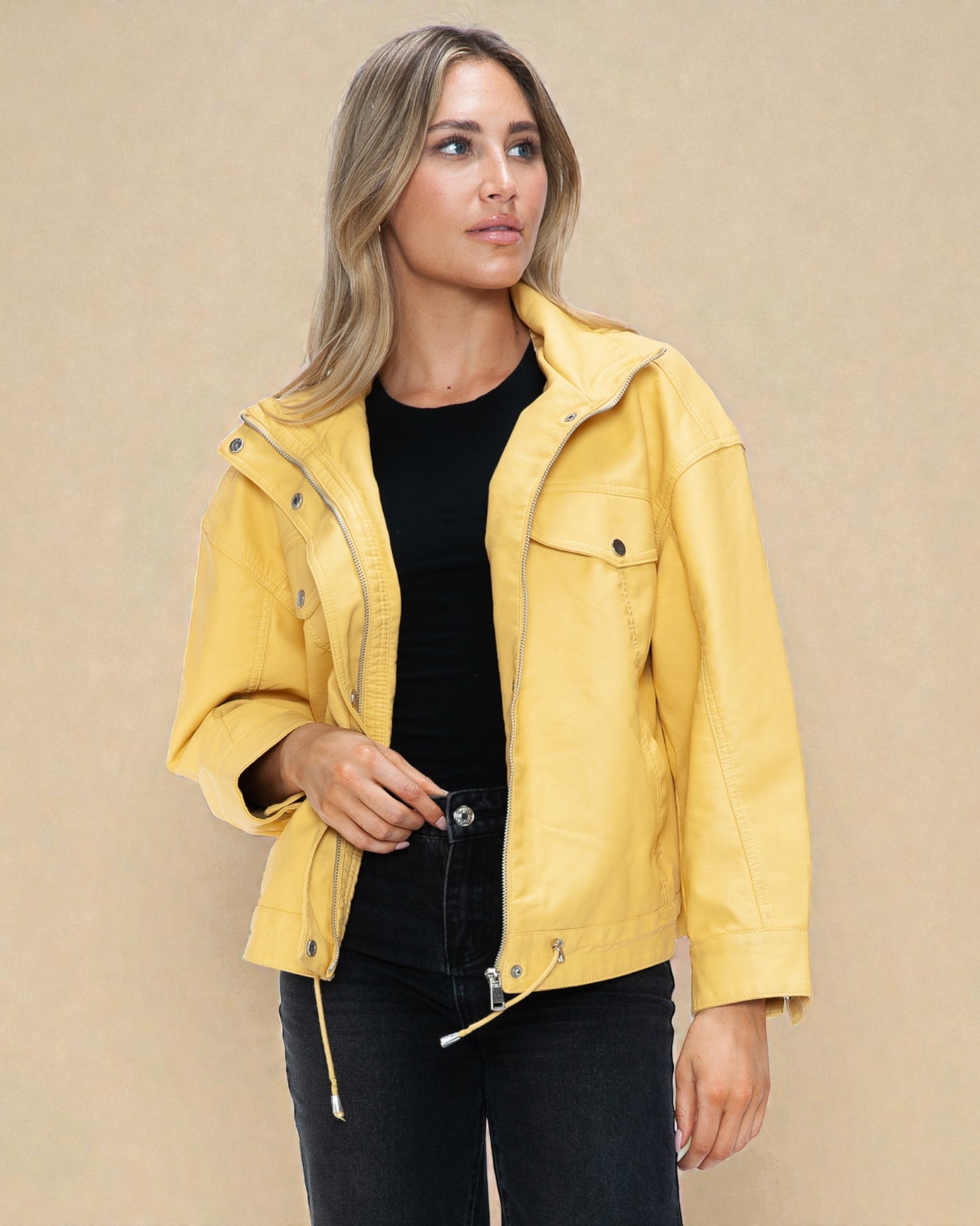 Woman wearing a yellow jacket against a beige background