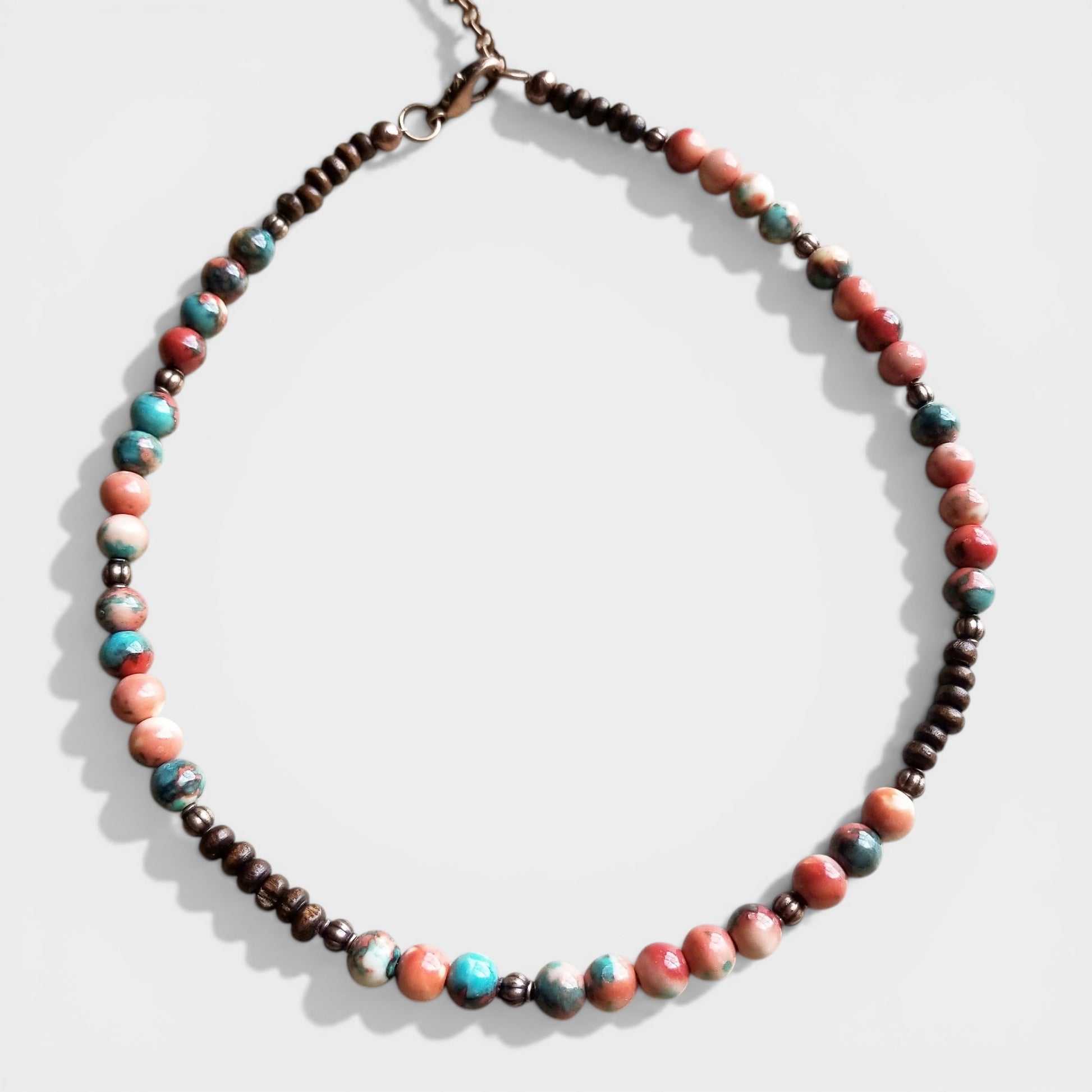Necklace with multicolored beads on a white background