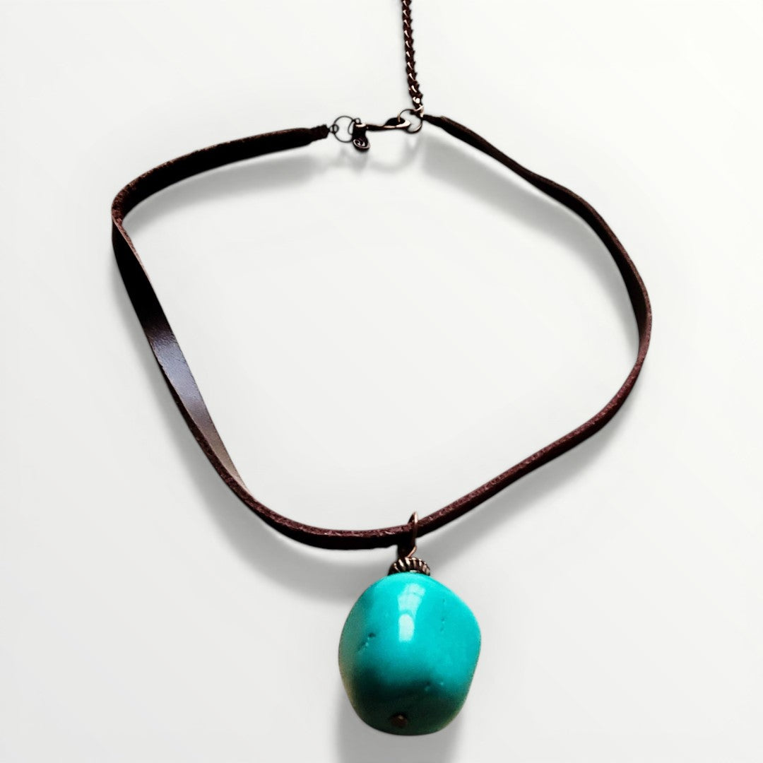 Necklace with a turquoise pendant on a white background
