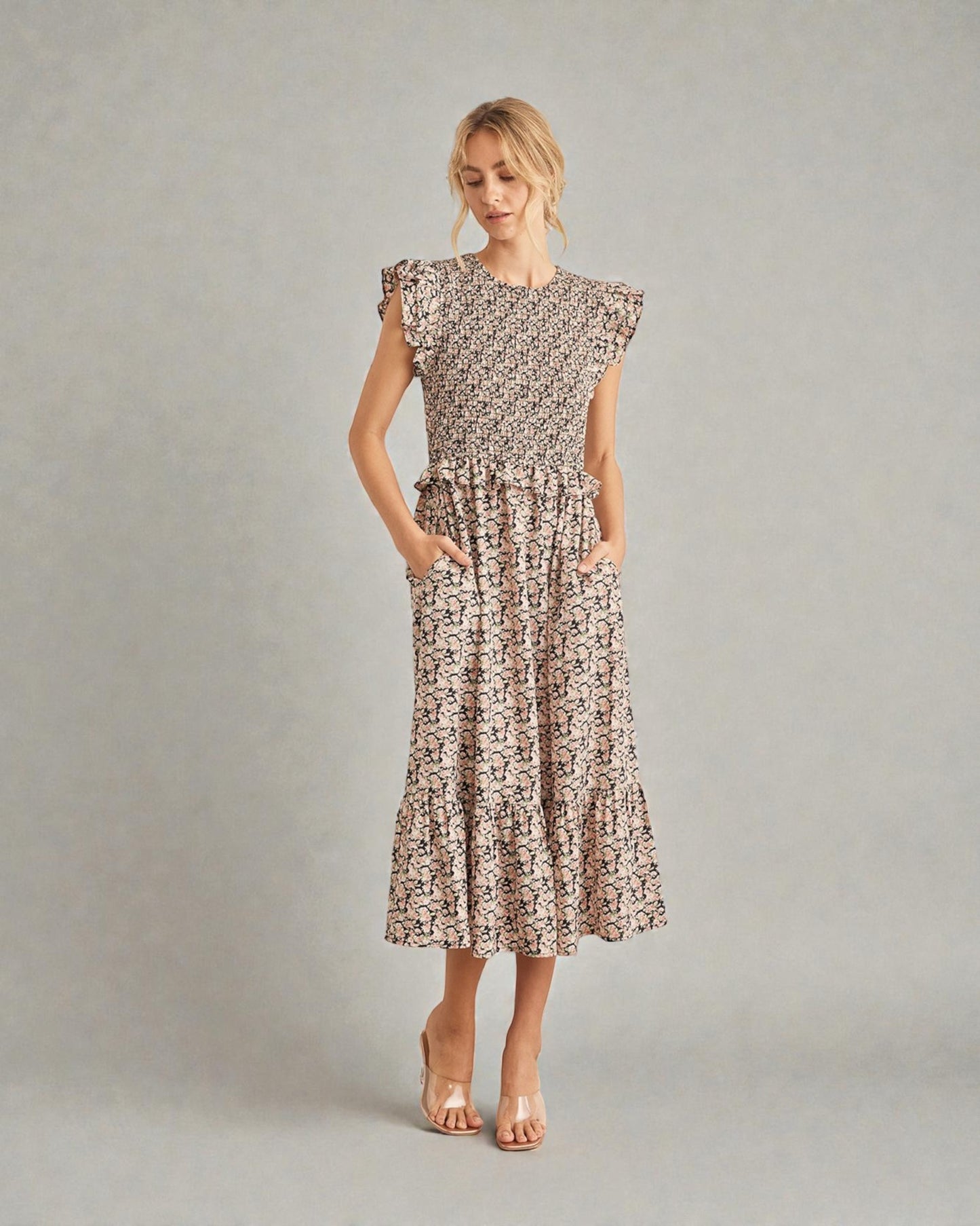 Woman wearing a patterned dress on a plain background