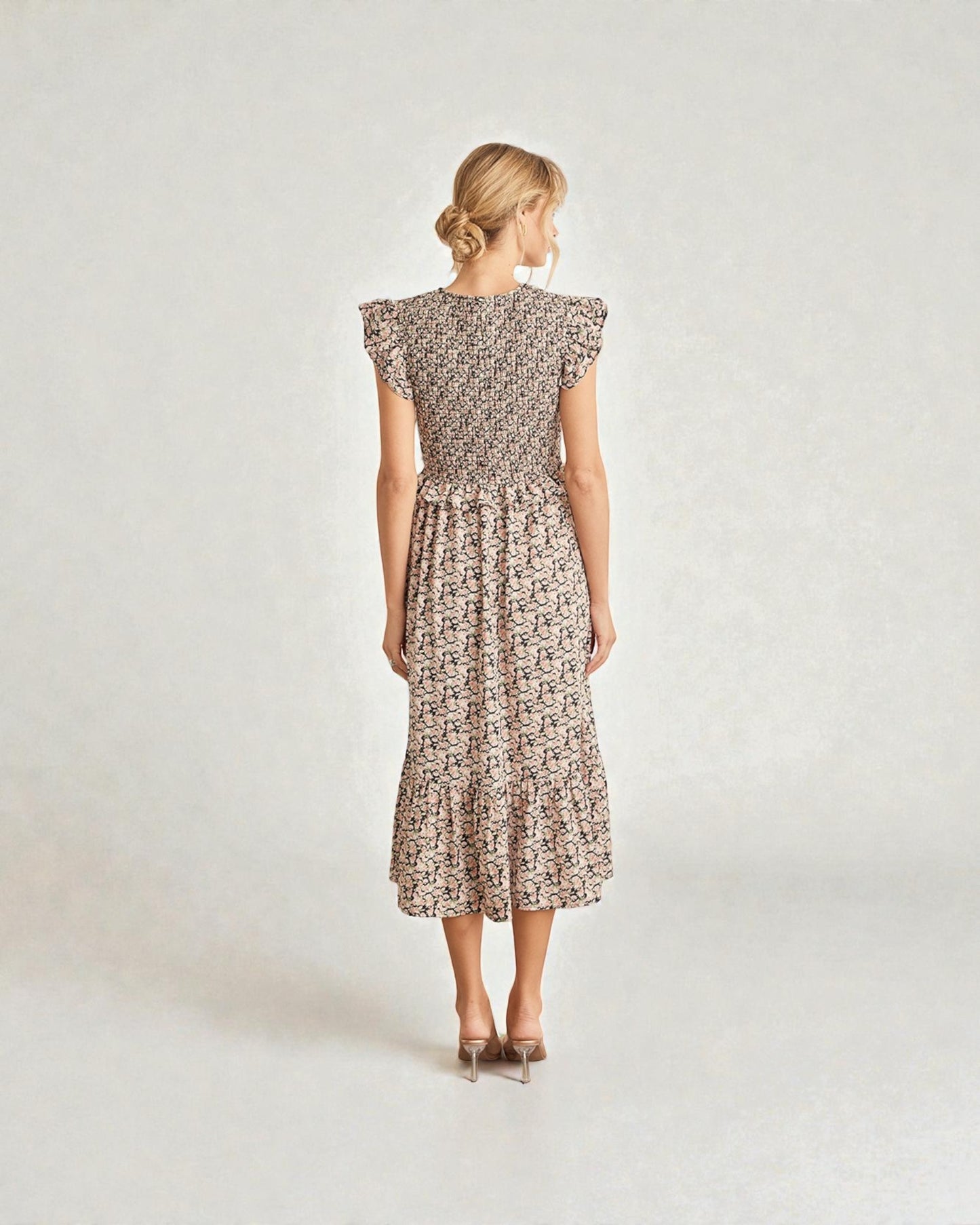 Woman wearing a floral dress on a plain background