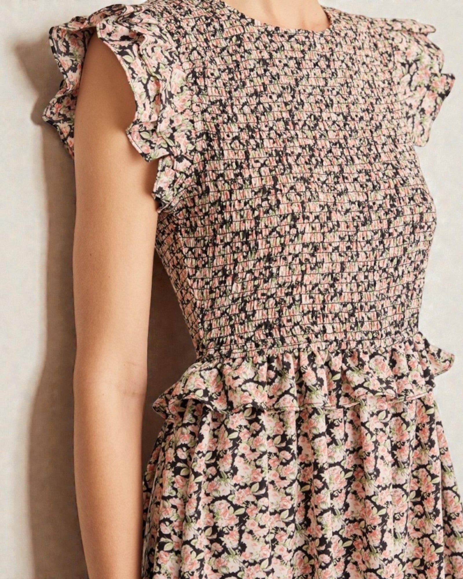 Floral dress with ruffled sleeves on a plain background
