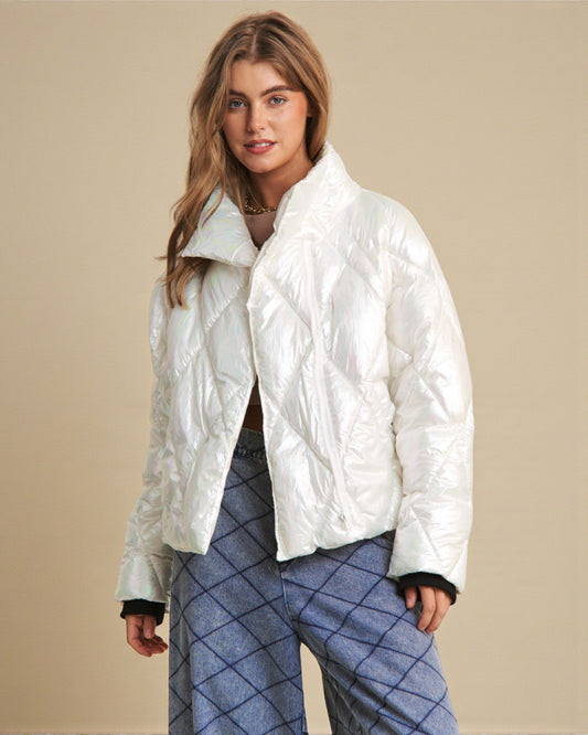 Woman wearing a white puffer jacket against a beige background
