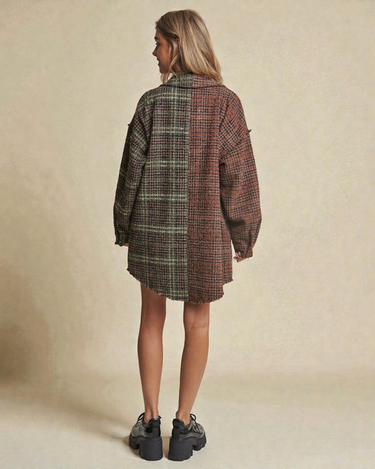 Person wearing a plaid shirt dress with a neutral background