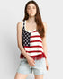 Person wearing a tank top with an American flag design on a plain background