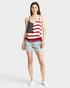Woman wearing a tank top with an American flag design on a plain background