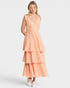 Woman wearing a peach-colored checkered dress on a white background