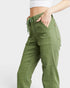 Green cargo pants worn by a person on a white background