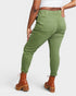 Person wearing green pants and brown boots on a white background