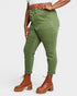 Person wearing green cargo pants and brown boots on a white background