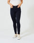 Person wearing black jeans and white sneakers on a white background