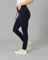 Person wearing navy blue jeans on a gray background