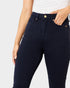 Navy blue jeans worn by a person on a light gray background