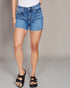Person wearing blue denim shorts on a plain background