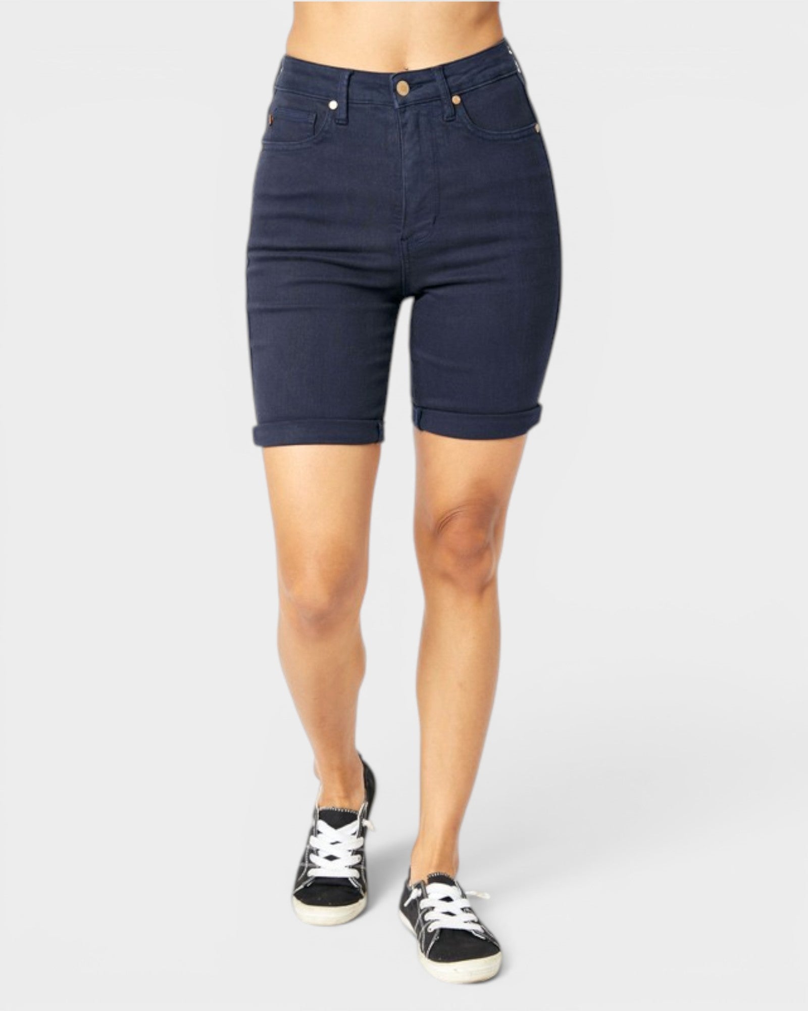 Navy blue shorts worn by a person on a white background