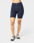 Navy blue shorts worn by a person on a white background