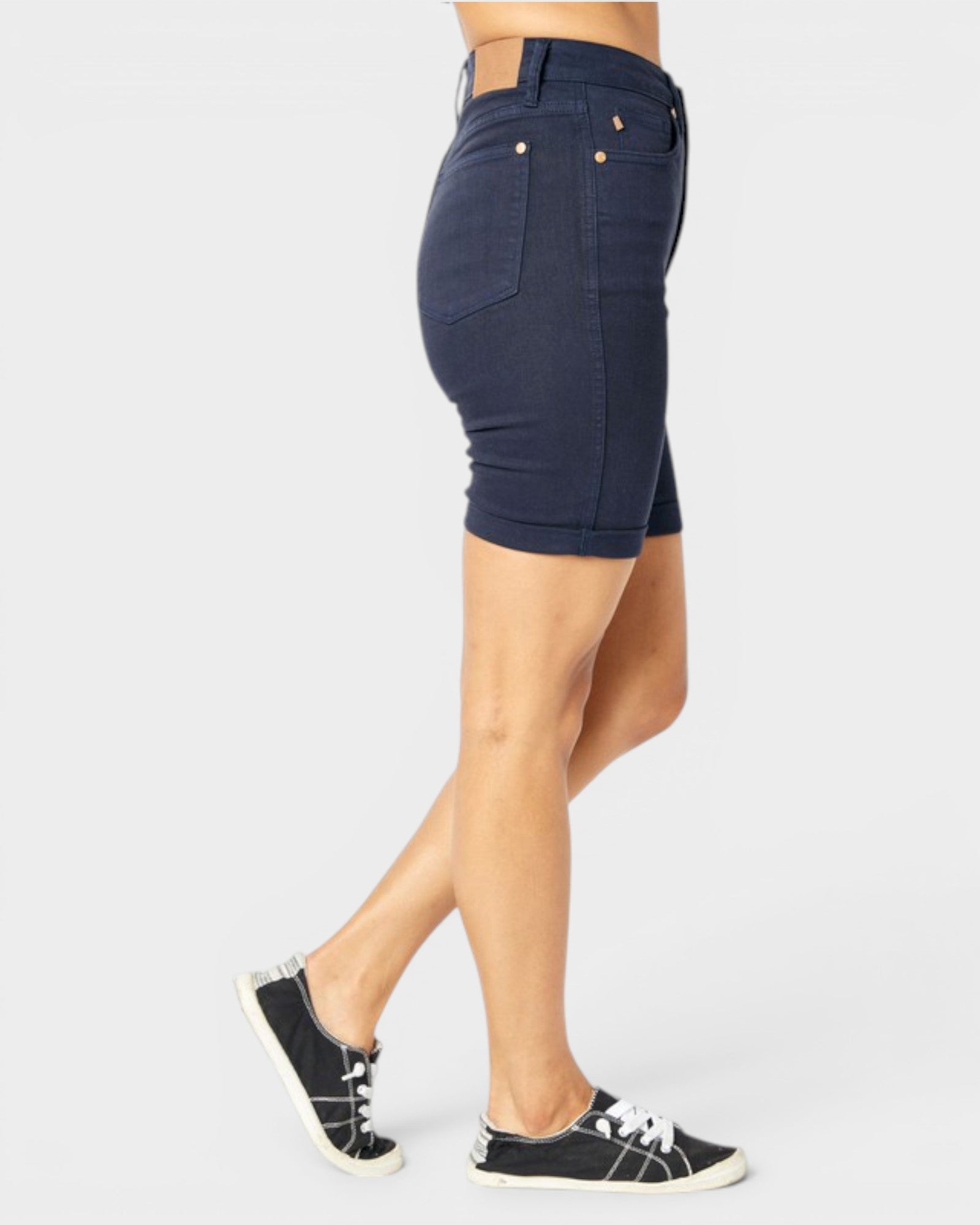 Navy blue denim skirt worn by a person on a white background
