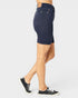 Navy blue denim skirt worn by a person on a white background