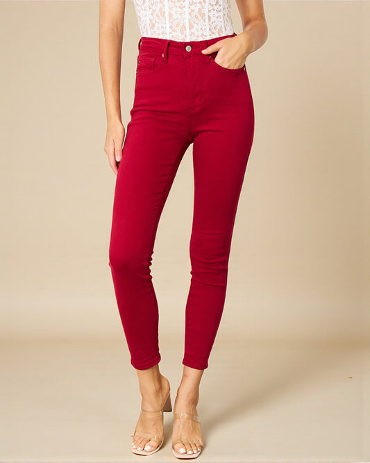 Red pants worn by a person on a beige background