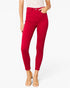 A model wearing bright red high-waisted skinny jeans, paired with a white lace top and clear high-heeled sandals, against a plain white background.