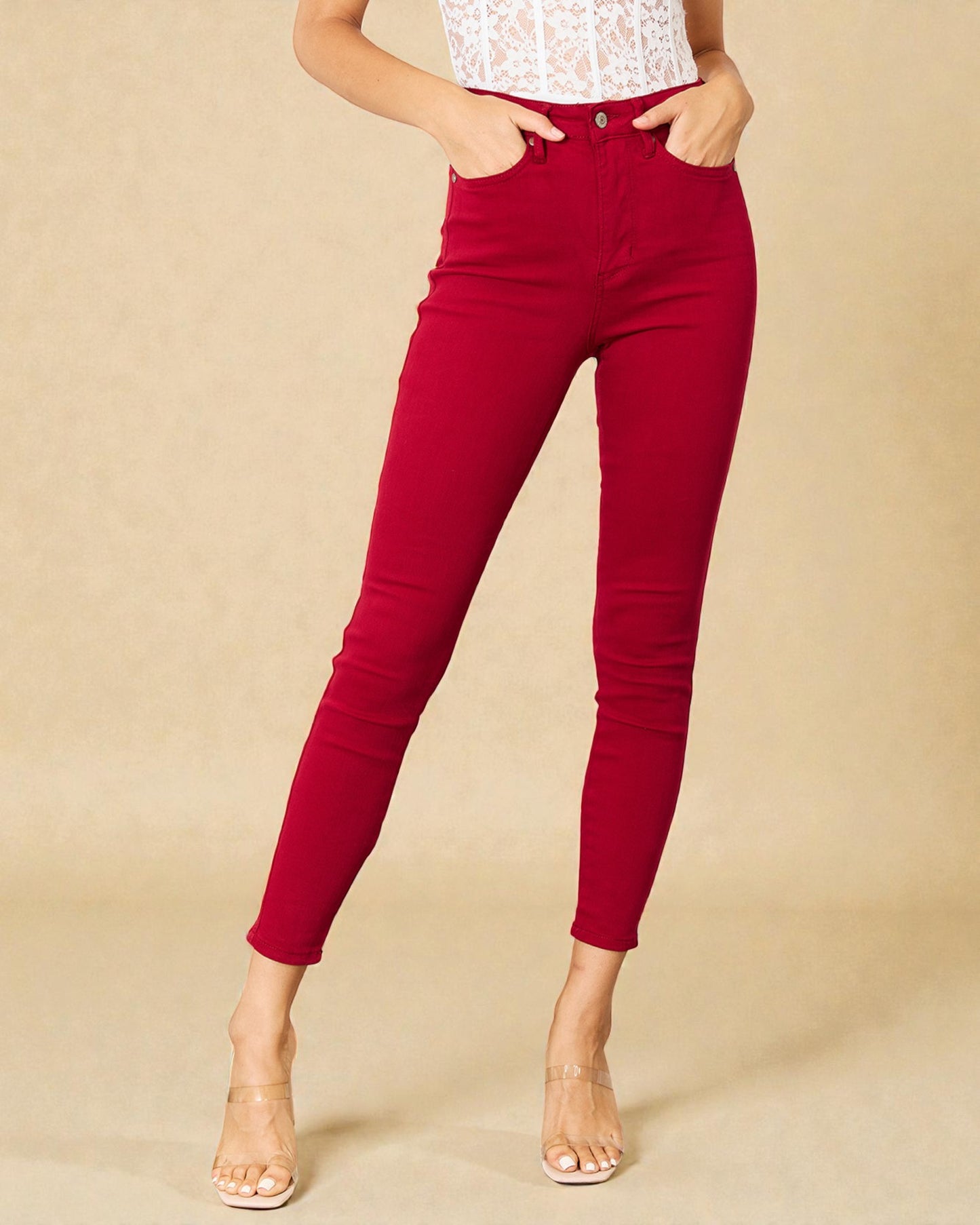 Red pants worn by a person on a beige background
