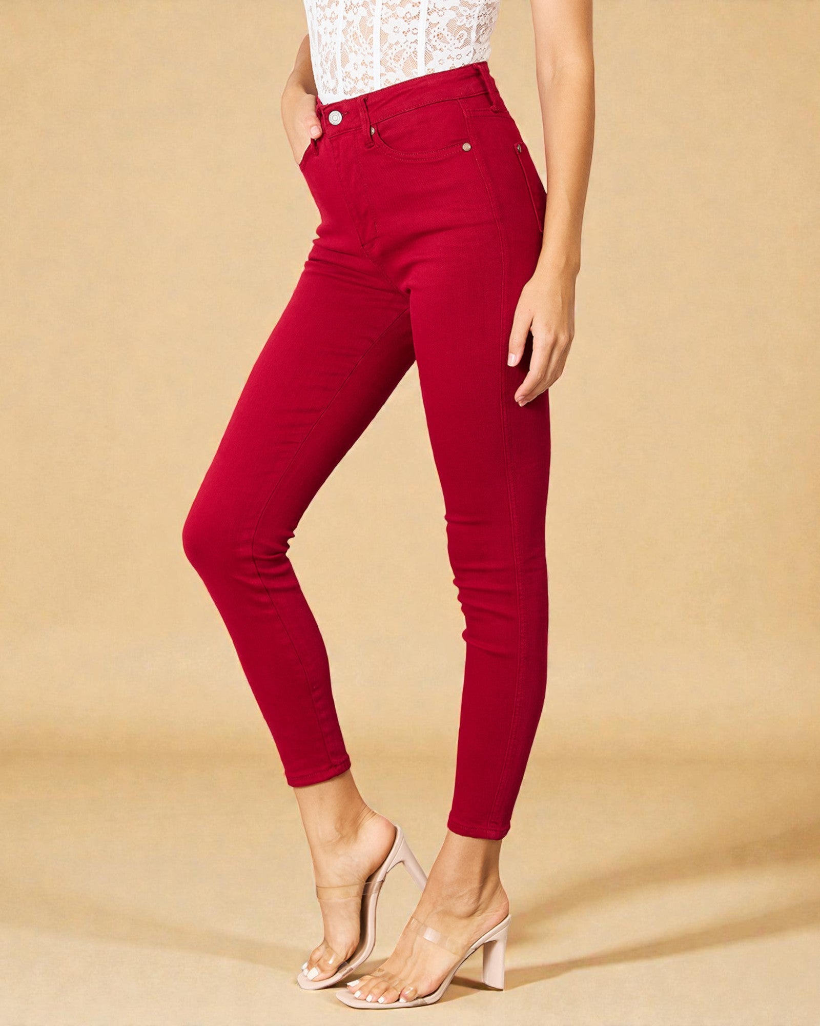 Red pants worn by a person on a beige background