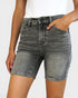 Person wearing gray denim shorts on a white background
